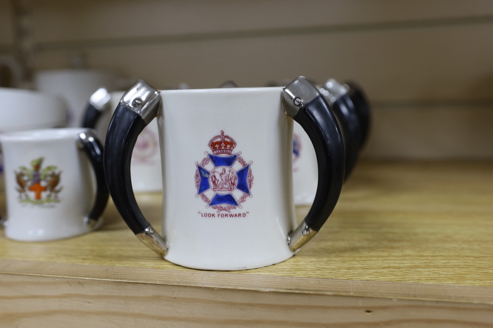 Society of Miniature Rifle Clubs - A large group of commemorative porcelain tea wares, three handled tygs and plates awarded for skill in rifle shooting, early 20th century